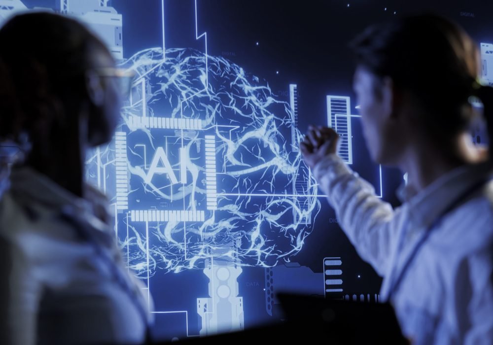 Computer scientists brainstorm ways to use AI cognitive computing to extract usable information from complex data. Data center employees implement artificial intelligence to process massive datasets